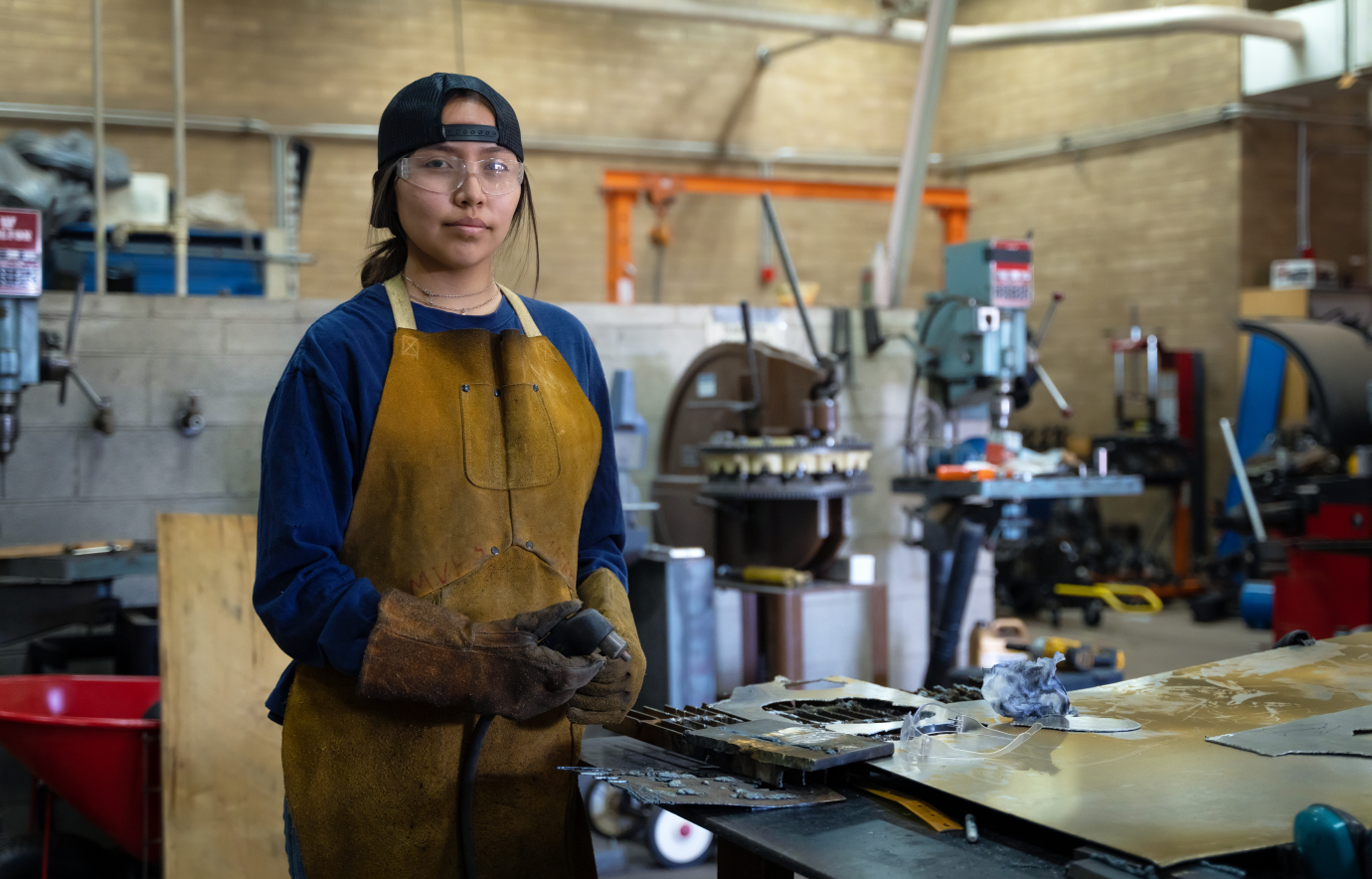A young person learning a trade in a workshop